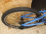 a blue bicycle that is sitting on the floor