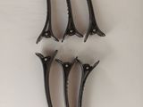 four pairs of pliers on a white surface with a white background