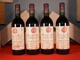 three bottles of red wine are lined up on a table