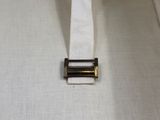 a close up of a belt on a white shirt