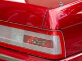 a close up of a red car with a license plate on it