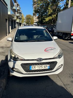 a white car that is parked on the side of the street
