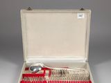 silverware in a case with a red handle and spoons in it