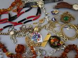 many different types of necklaces and bracelets laid out on a table