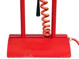 an image of a red metal device with a coil