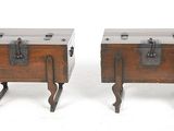 pair of antique wooden trunks with leather handles on legs