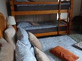 a bed with two bunk beds and a mirror in the room