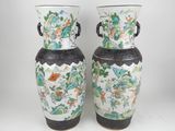 pair of chinese vases with floral designs on them on a white background