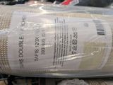 a roll of fabric wrapped in plastic on a table