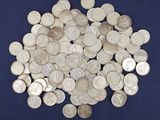 pile of silver coins on a blue background