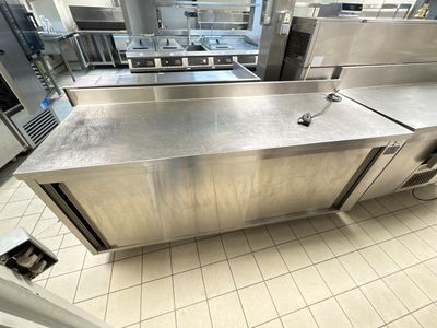 a large stainless steel counter in a commercial kitchen