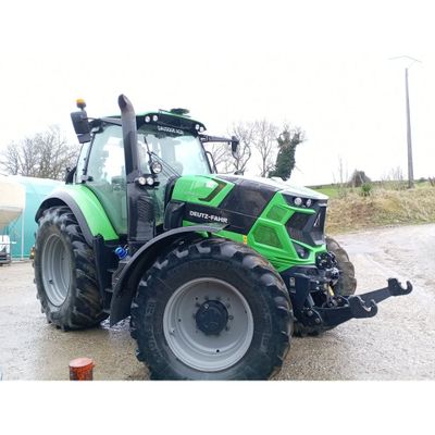 un tracteur vert garé sur le bord de la route