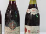 three bottles of wine are lined up on a table