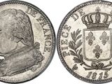 a silver coin with a crown on top of it