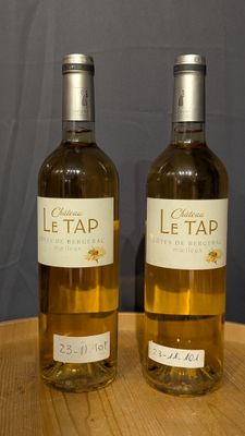two bottles of wine that are sitting on a table