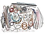 many different types of necklaces and bracelets laid out on a table