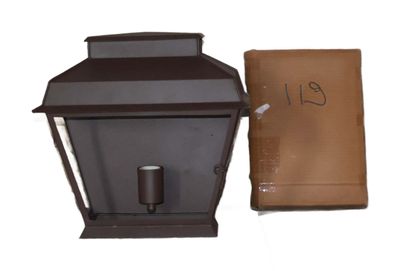 a brown lantern with a brown bag next to it
