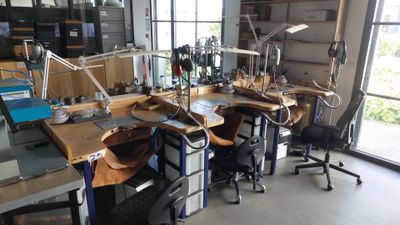 many desks and chairs in a room with lots of windows
