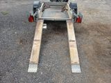 a trailer with a trailer attached to it in a parking lot