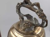 a bell with a dragon on it on a stand