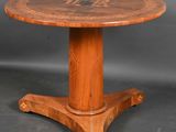 a wooden table with a round top and a wooden base