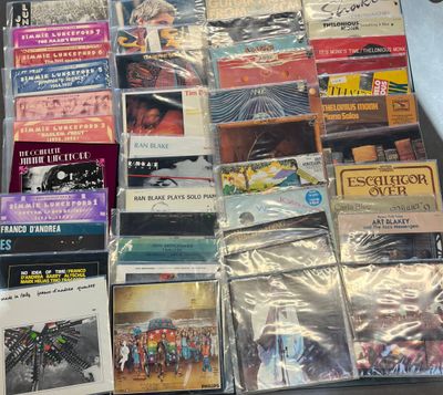 a lot of cd ' s that are sitting on a table