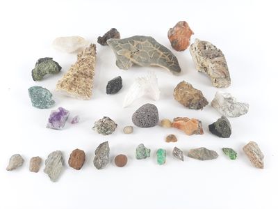 a pile of rocks and stones on a white surface