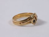 a close up of a gold ring on a white surface