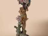 a figurine of a woman with flowers on her head