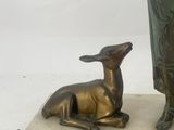 bronze statue of a woman and a deer on a marble base