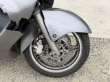 a close up of a motorcycle parked on the side of the road