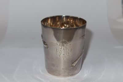 a silver cup that is sitting on a table