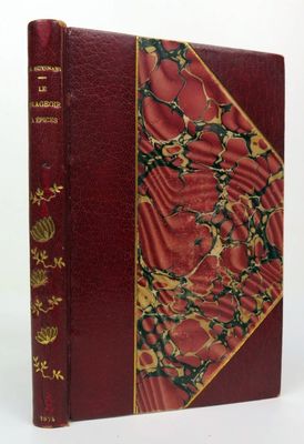 an old book with a red cover and gold decorations on it