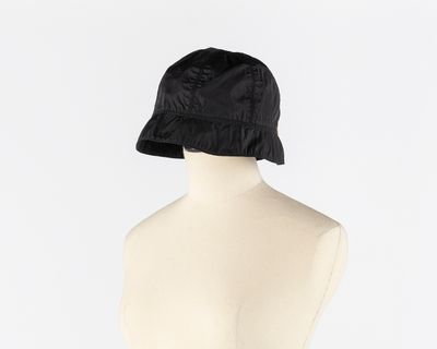 the back of a mannequin torso with a black hat on it