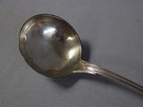 a silver spoon with a spoon handle on a table