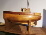 a wooden model of a boat sitting on a table