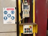 a machine that is sitting on the floor next to a wall