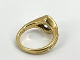 a close up of a gold ring with a diamond on it