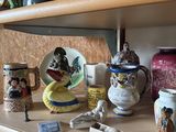 a shelf that has many different types of vases on it
