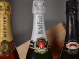 three bottles of wine sitting on top of a wooden box