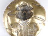 a gold coin with a picture of a man on it