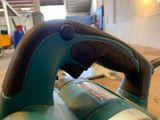 a close up of a sander on a table in a room