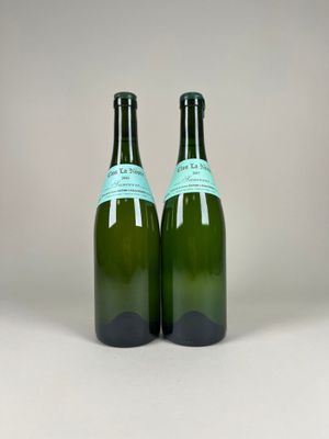two bottles of wine sitting next to each other on a table