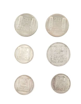 six different types of silver coins on a white surface