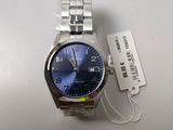 a close up of a watch on a table with a price tag