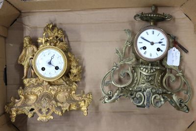 deux horloges rangées dans une boîte, avec des étiquettes dessus