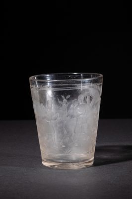 a glass with ice in it sitting on a table