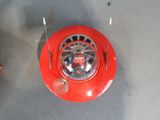 a small red object on the floor with a toothbrush in it