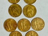 six types différents de pièces d'or sur une surface blanche