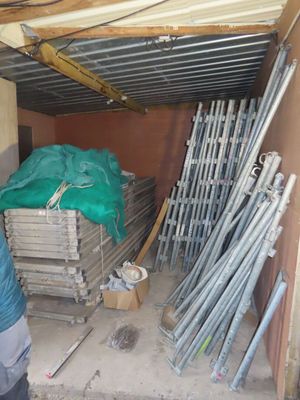 a man that is standing next to a pile of pipes